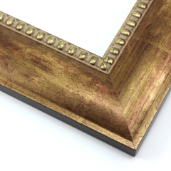 This solid wood frame features a wide clam shell profile finished with striking gold foil over a red-brown base.  The result is a veined, fingerprint design that gives the frame a traditional, classic look.  A beaded inner lip completes the design, tipped with the same colouring.

2.5 " width: ideal for large images.  Border bold oil paintings or prints, or fine art photographs.