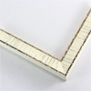 This decorative 1 1/4 " frame imitates the natural bark markings of a birch tree. Cream white paint is distressed in vertical lines, and along the face edge, to reveal a brown grey finish underneath. The profile is solid cream white and features a smooth indent all the way around.