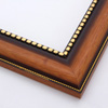 This solid wood, steeply curved frame features a natural, walnut finish that fades into deep brown approaching a gold foil-beaded inner lip. The outer edge has a slender dashed border in gold foil.
2 " width: ideal for medium images. Add some elegance to a family portrait, or border an old oil painting or print with this timeless frame.