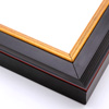 This steep-edged, stepped crown moulding frame features a matte antique black finish delineated by a thin red outer corner. The inside lip contrasts with a bold gold foil. The unique 1.5 " outside depth gives this frame a deep, majestic appearance.
2.125 " width: ideal for medium and large images. Give a family photo a royal air, or border an elegant oil painting or print with this frame.