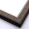 An ornate, solid wood frame featuring an intricate design overlaid with elegant silver leaf, and lightly antiqued. A shallow scooped profile and unadorned inner edge draw the eye inward. A dark brown outer edge highlights the design.
1.75 " width: ideal for medium-sized artworks. Oil paintings, prints and formal family photos will be equally at home encased in this traditional frame.