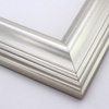 This high swan profile wood frame features a reverse slope and 1.5 " maximum depth. The gentle ridges are encased in glossy silver foil - an elegant but simple design.
2.5 " width: ideal for medium and large images. Pair with old, grayscale portraits and bold paintings or Giclée prints.