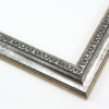 This classic, Victorian-style frame features a solid wood, reverse scoop profile. The relief-detailed inner lip and sloped face are a textured silver foil, edged in a subtle bevel.
1.25 " width: ideal for small images. Border an acrylic or oil painting or print with this antiqued, high fashion frame.